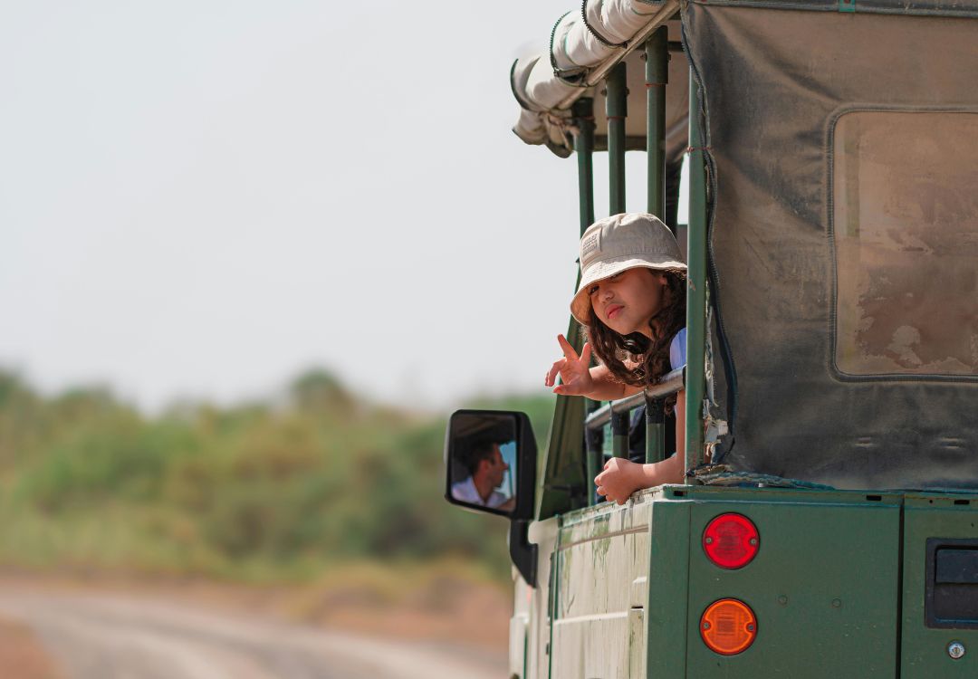 child on safari adventure in open top vehicle